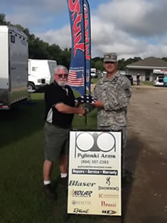 Colonel Menhart awarding certificate and flag to Laurence Pylinski